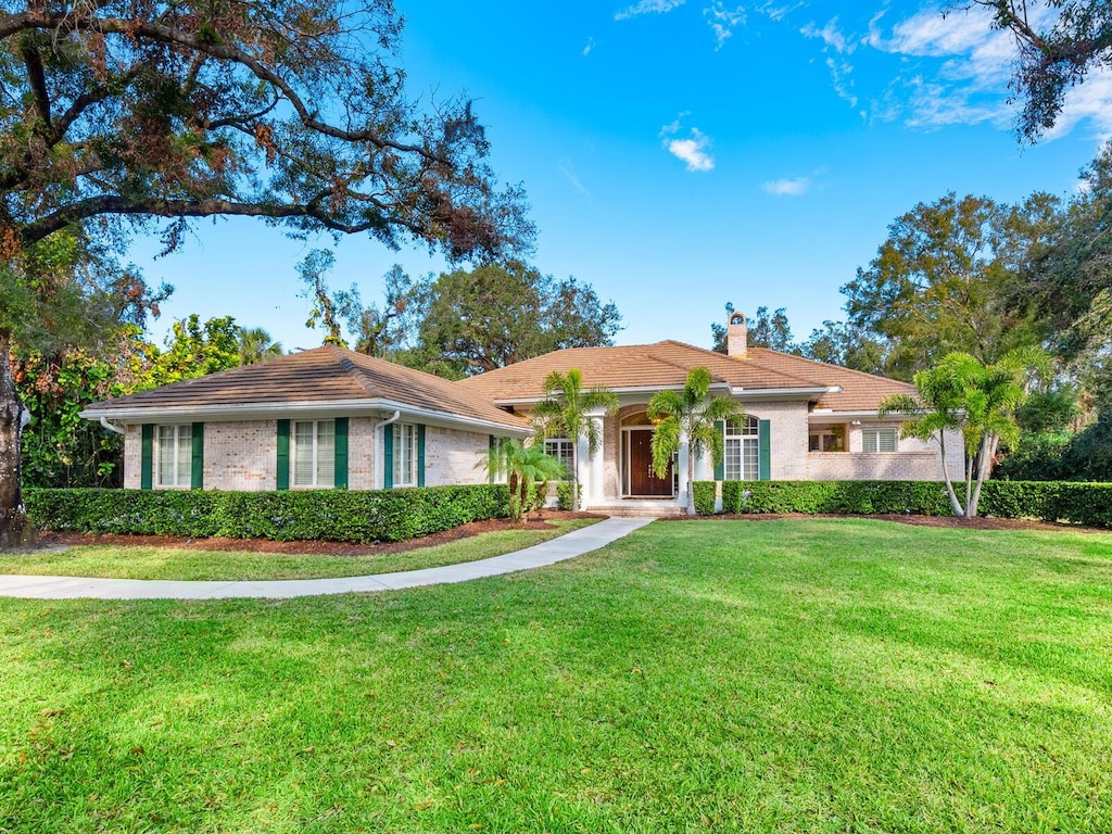 ranch-style home with a front yard