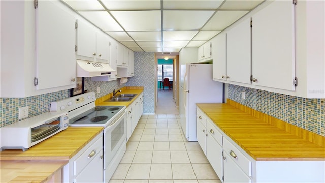 kitchen with white cabinetry, sink, tasteful backsplash, and white appliances