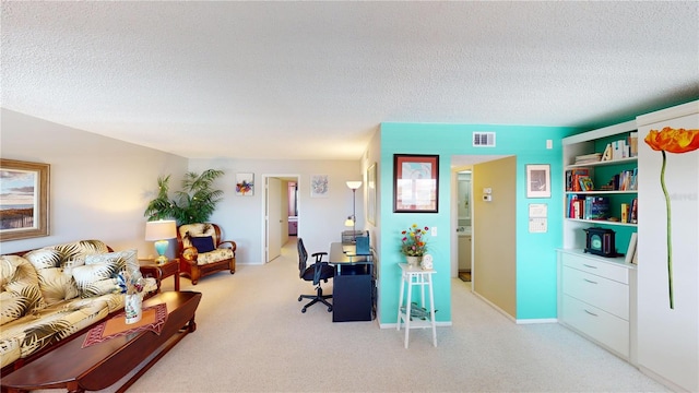 carpeted office space featuring a textured ceiling