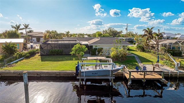 view of dock with a lanai, a water view, and a lawn