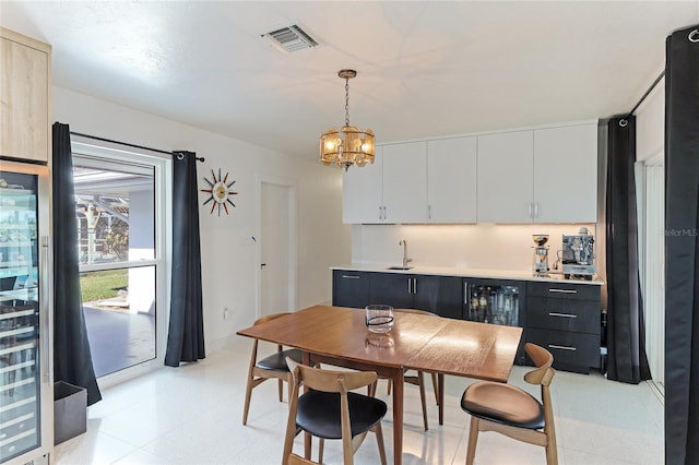 dining space with a notable chandelier and sink