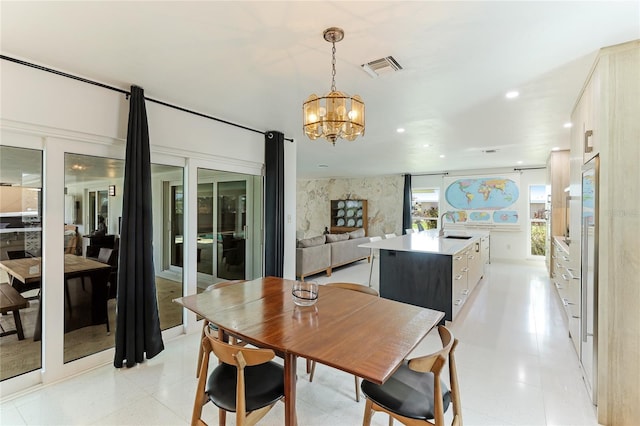 dining area featuring sink and a notable chandelier