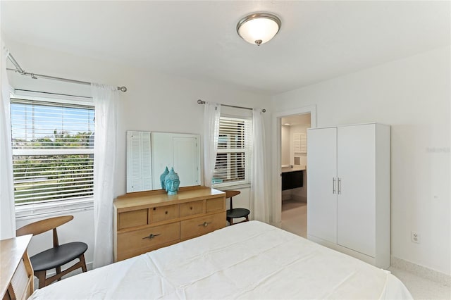 bedroom featuring multiple windows and ensuite bath