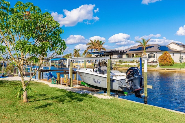 view of dock featuring a lawn and a water view