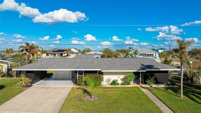 view of front of home with a carport and a front yard