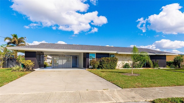 ranch-style house featuring a carport and a front yard