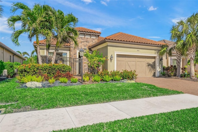 mediterranean / spanish house with a garage and a front yard