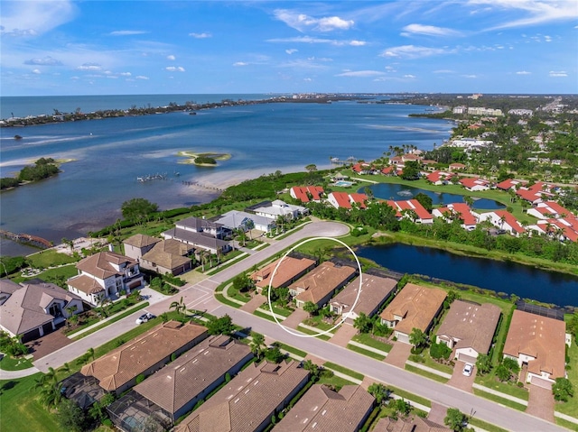 birds eye view of property with a water view