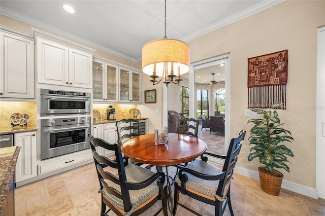 dining room featuring crown molding and ceiling fan with notable chandelier