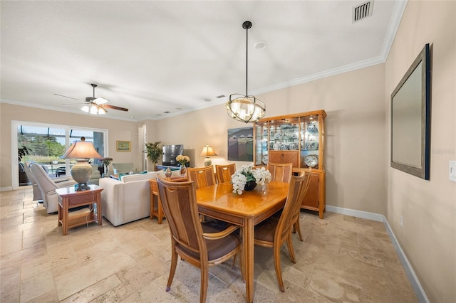 dining area featuring ornamental molding and ceiling fan with notable chandelier