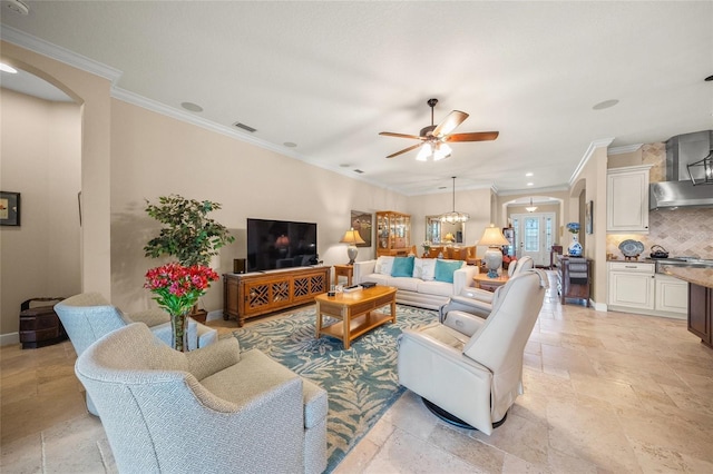 living room with ceiling fan and ornamental molding