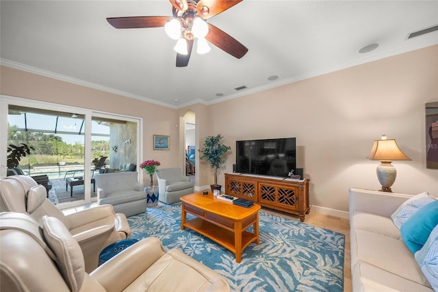 living room with ceiling fan and ornamental molding