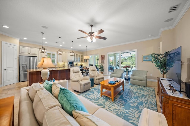 living room with ornamental molding and ceiling fan