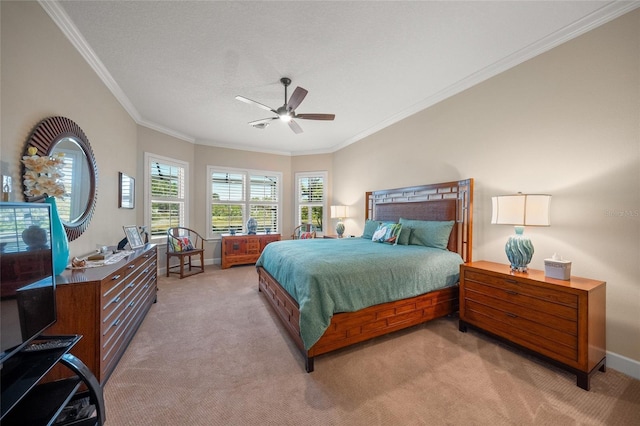 carpeted bedroom featuring crown molding and ceiling fan