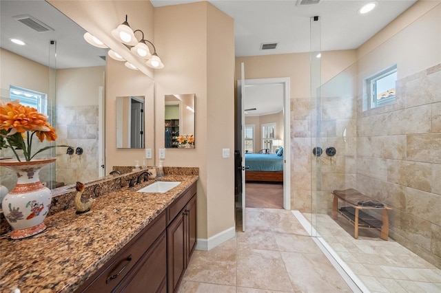 bathroom featuring vanity and tiled shower