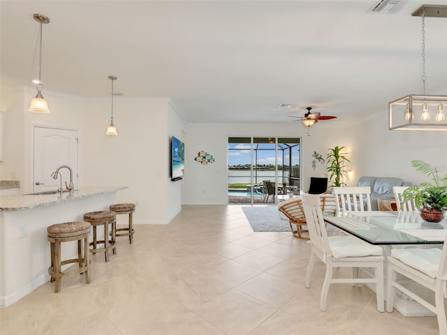 dining room featuring light tile patterned floors, baseboards, a ceiling fan, and crown molding