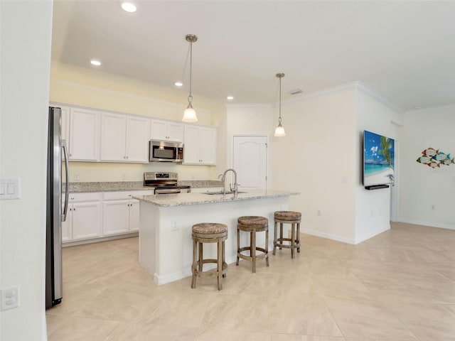 kitchen featuring white cabinets, crown molding, stainless steel appliances, and a sink