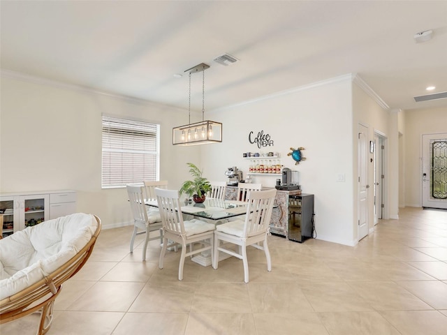 dining room with visible vents, crown molding, baseboards, and light tile patterned flooring