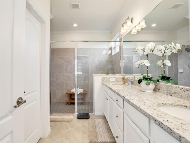 bathroom with a sink, a stall shower, double vanity, and crown molding