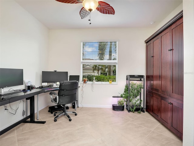 office area with baseboards, a ceiling fan, and light tile patterned flooring