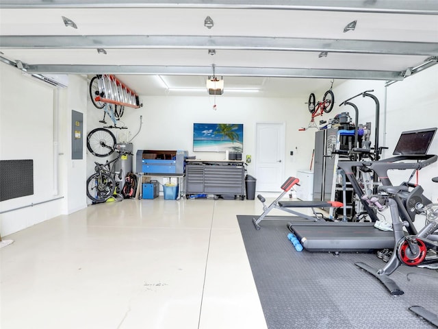 workout area with a garage and electric panel