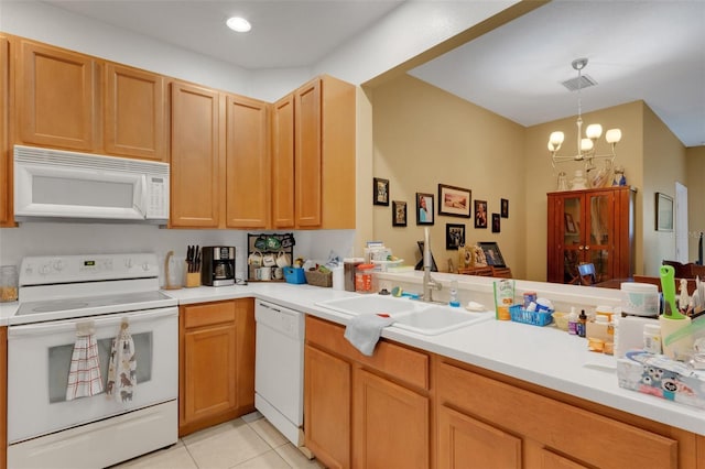 kitchen featuring white appliances, an inviting chandelier, sink, kitchen peninsula, and light tile patterned flooring