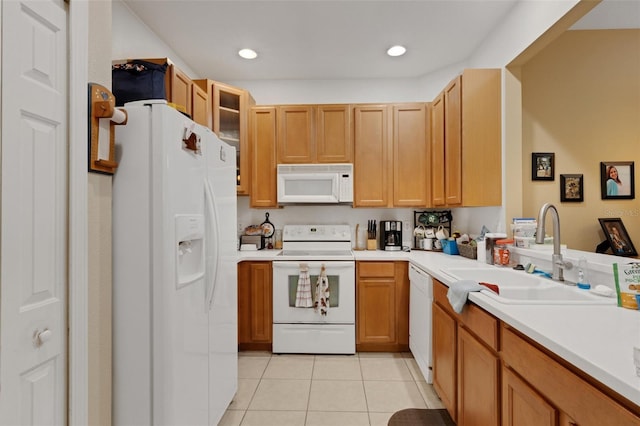 kitchen with sink, white appliances, and light tile patterned flooring