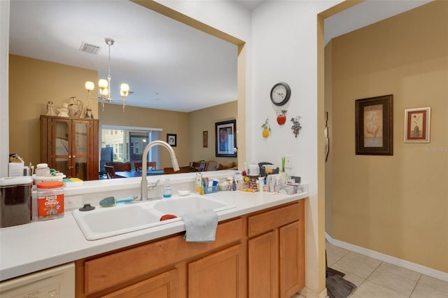 kitchen with white dishwasher, a chandelier, hanging light fixtures, light tile patterned floors, and sink