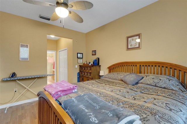 bedroom featuring ceiling fan, hardwood / wood-style floors, and a closet