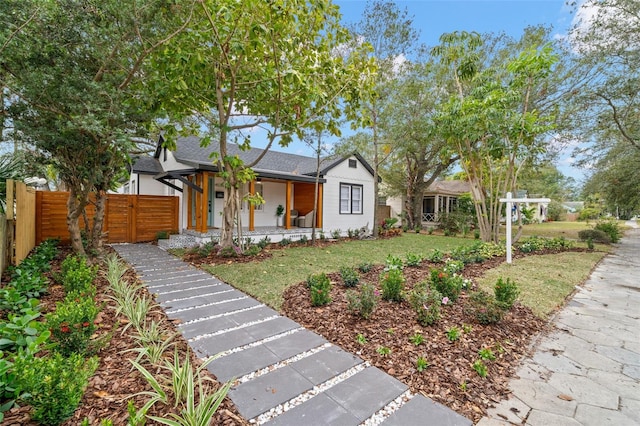 view of front of property with a front yard and covered porch