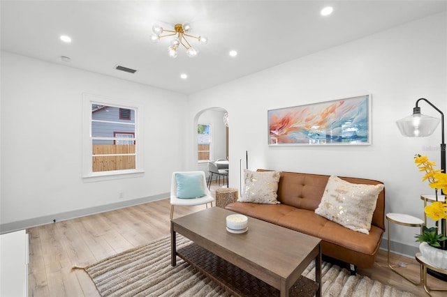 living room featuring a chandelier and wood-type flooring