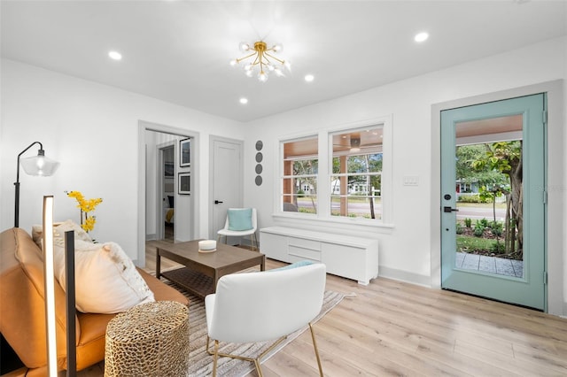 interior space featuring radiator, an inviting chandelier, and light hardwood / wood-style floors