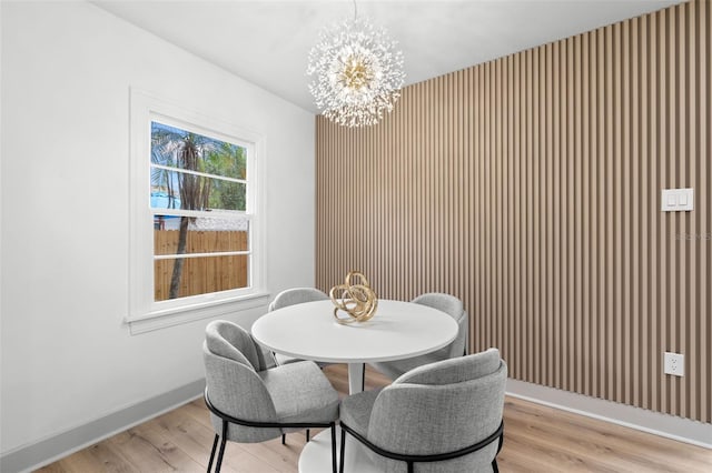 dining area with a chandelier and light hardwood / wood-style floors