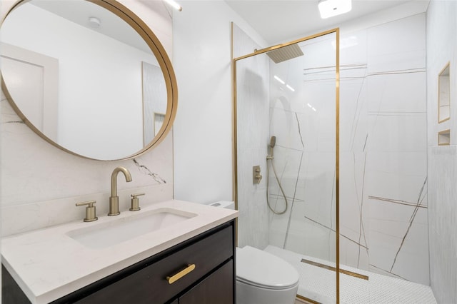 bathroom with toilet, vanity, and a tile shower