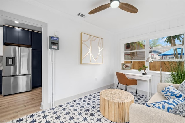 interior space featuring ceiling fan and crown molding