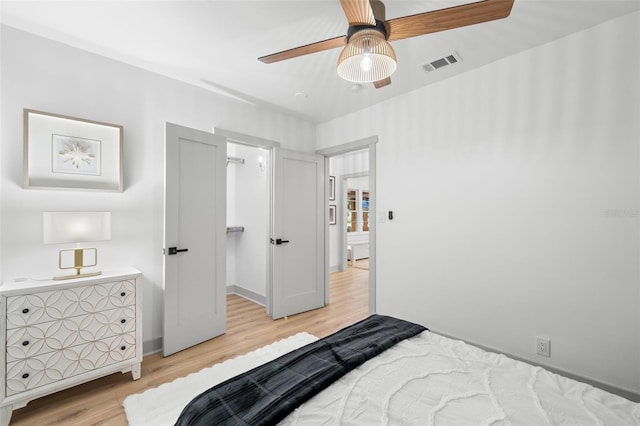4536 1st Ave N, Saint Petersburg, FL 33713 - bedroom featuring baseboards, visible vents, a spacious closet, light wood-style floors, and ceiling fan