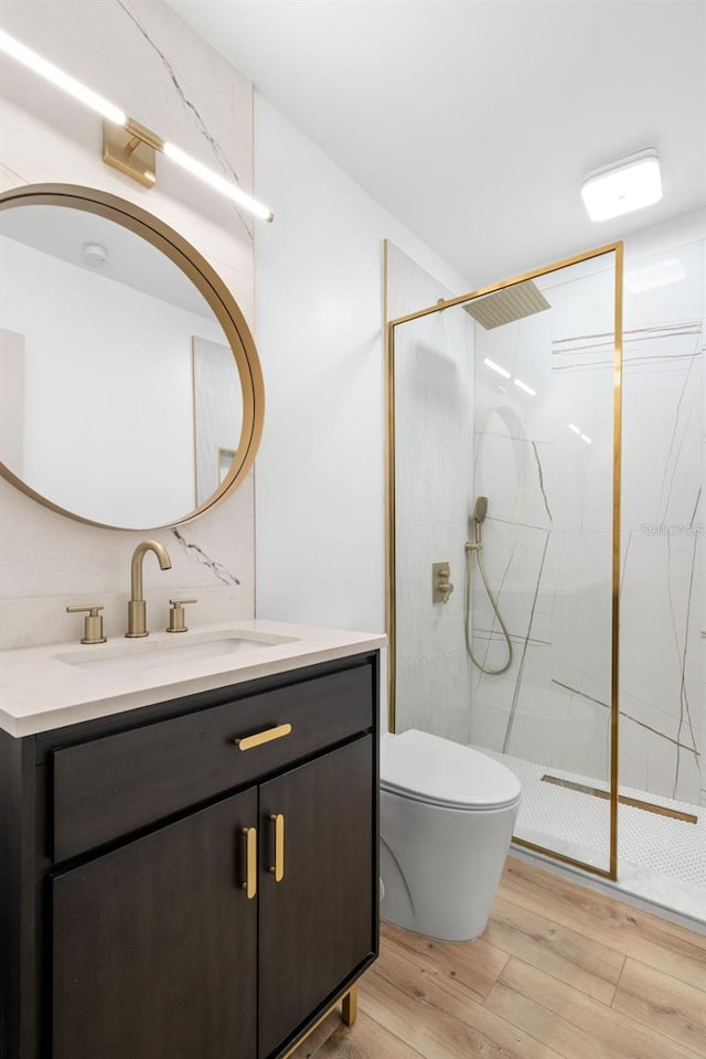 4536 1st Ave N, Saint Petersburg, FL 33713 - bathroom featuring toilet, vanity, wood finished floors, and a marble finish shower