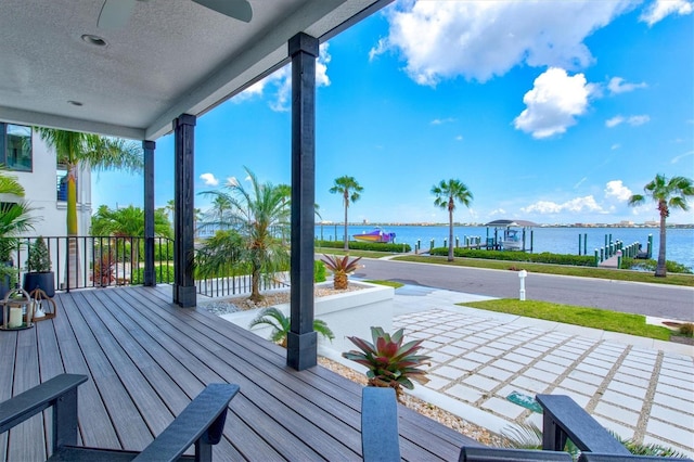 wooden terrace featuring a water view and ceiling fan