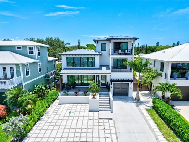 view of front of house featuring a garage and a balcony