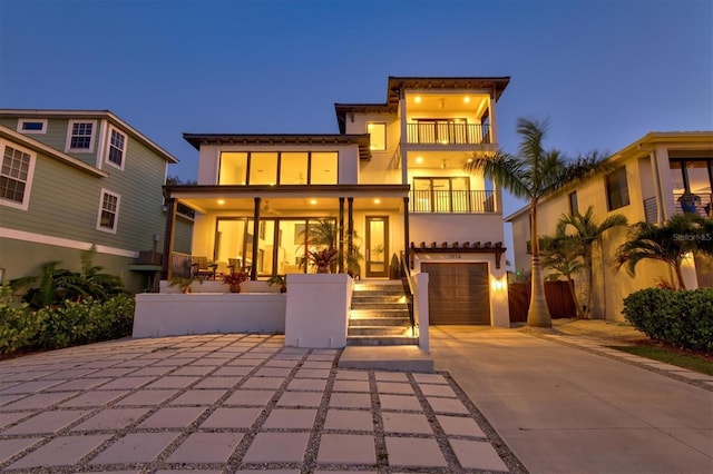 view of front facade featuring a garage and a balcony