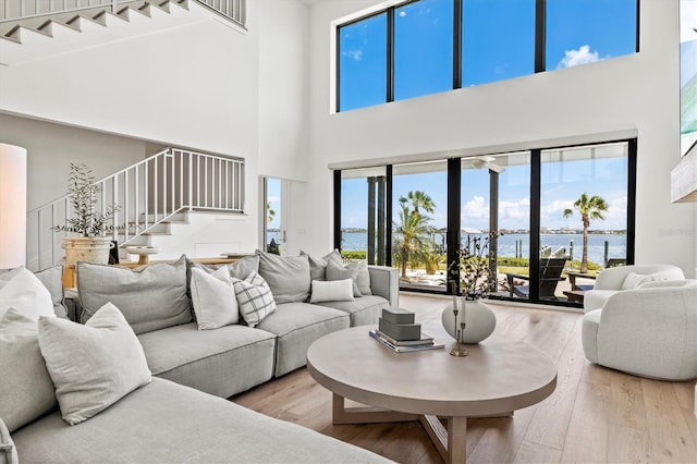 living room with a water view and hardwood / wood-style floors