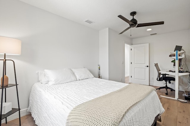 bedroom with wood-type flooring and ceiling fan