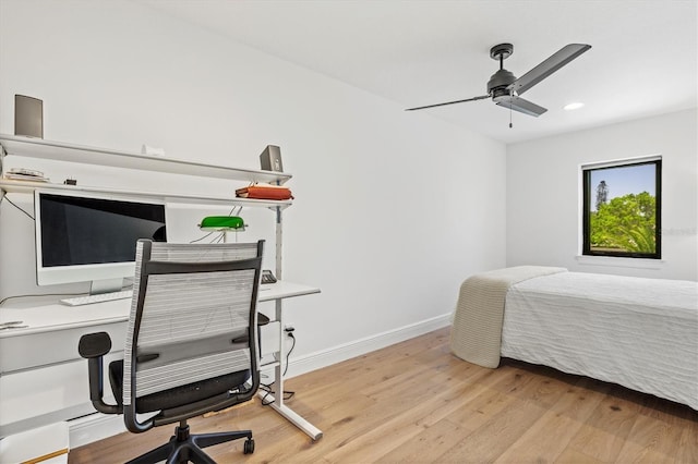 bedroom with ceiling fan and light hardwood / wood-style floors