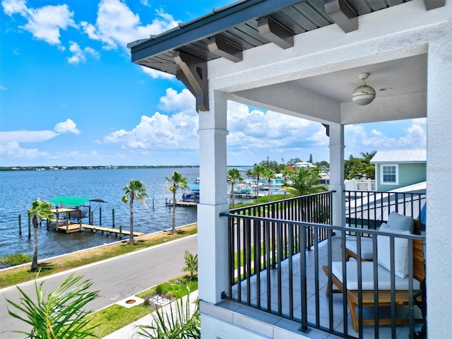 balcony with a water view and ceiling fan