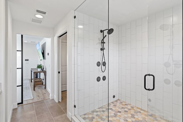 bathroom featuring a shower with shower door