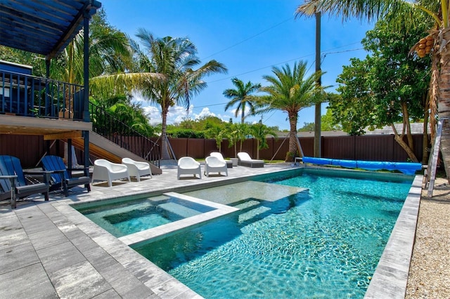 view of swimming pool with an in ground hot tub and a patio area