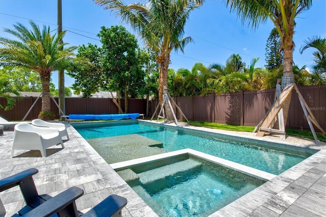 view of pool with an in ground hot tub