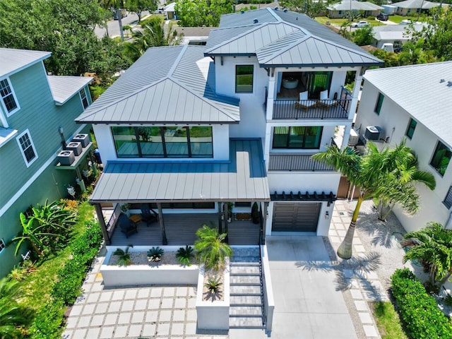 view of front of home featuring a garage and a balcony