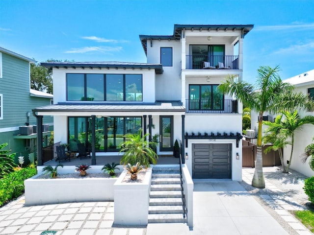 view of front of house featuring a garage and a balcony