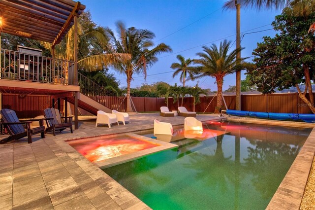 view of pool with a patio and an in ground hot tub